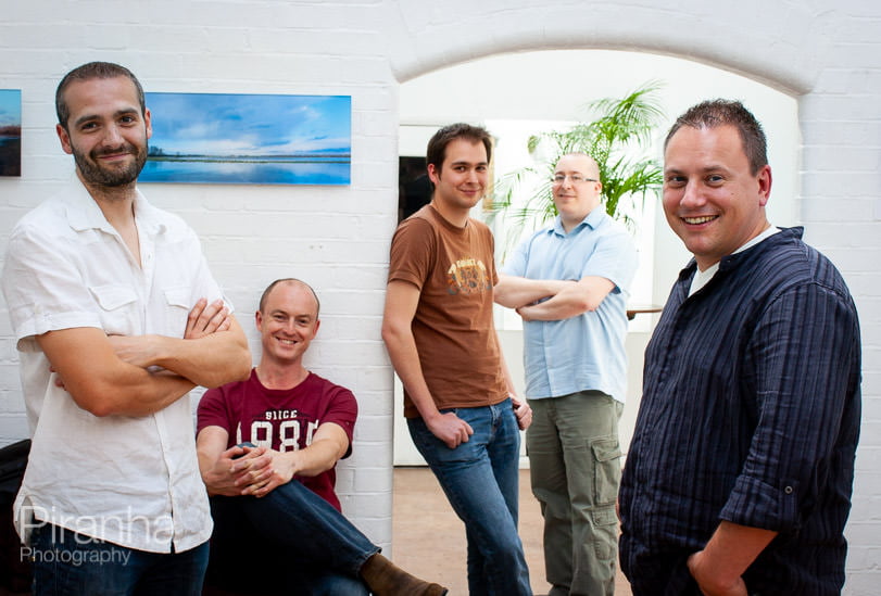 Relaxed group photograph of team for gaming company