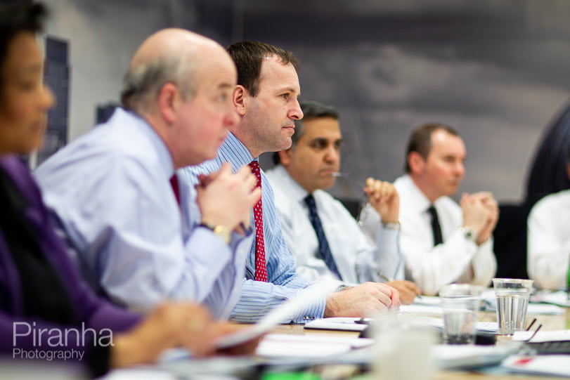 Board room photograph of board in a meeting