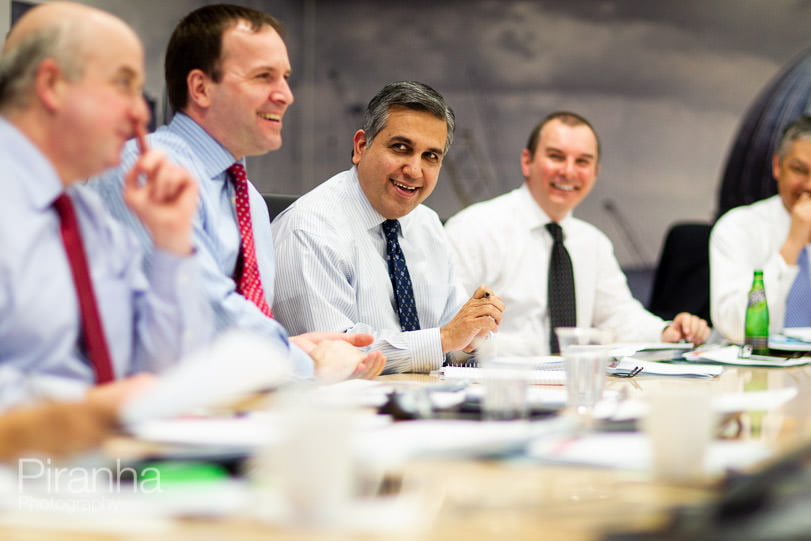 Board room photograph of board in a meeting