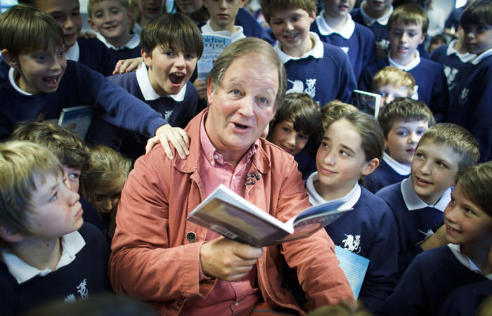 Photograph of Michael Morpurgo reading to the children at the Unicorn School, Abingdon