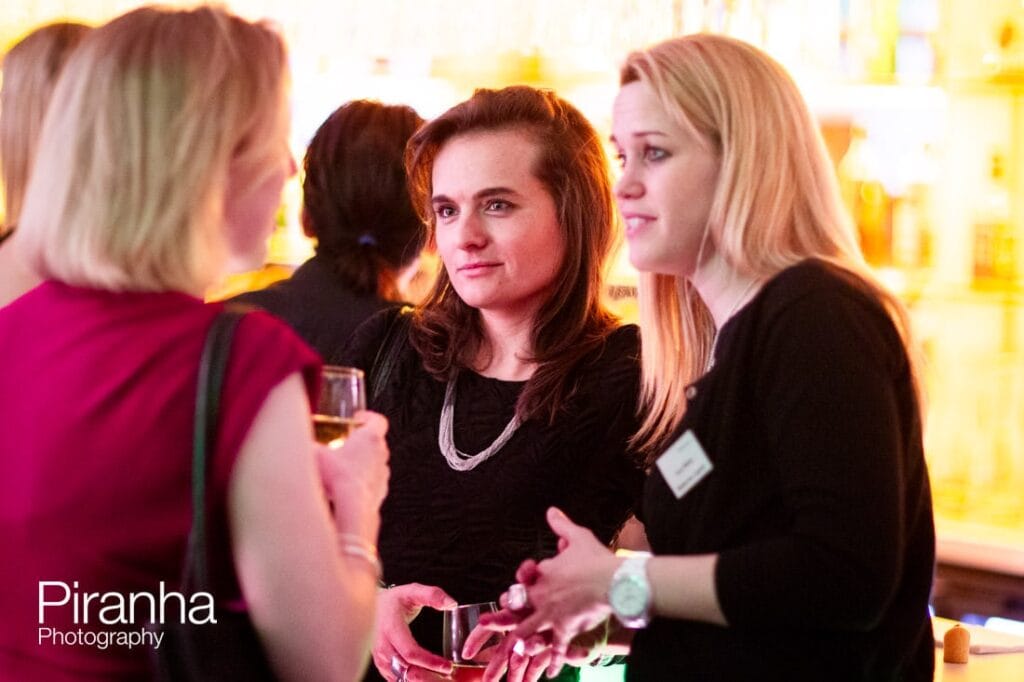 Christmas party photographer - guests chatting in London at party