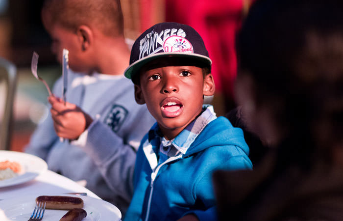 Boy Eating Breakfast at London Charity Event