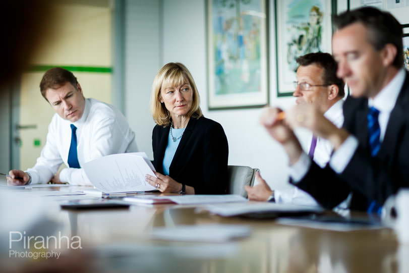 Directors photographed in meeting enivornment