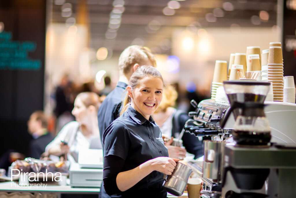 Stand photographer at Excel in London - photography of waitress working on the stand in black and white
