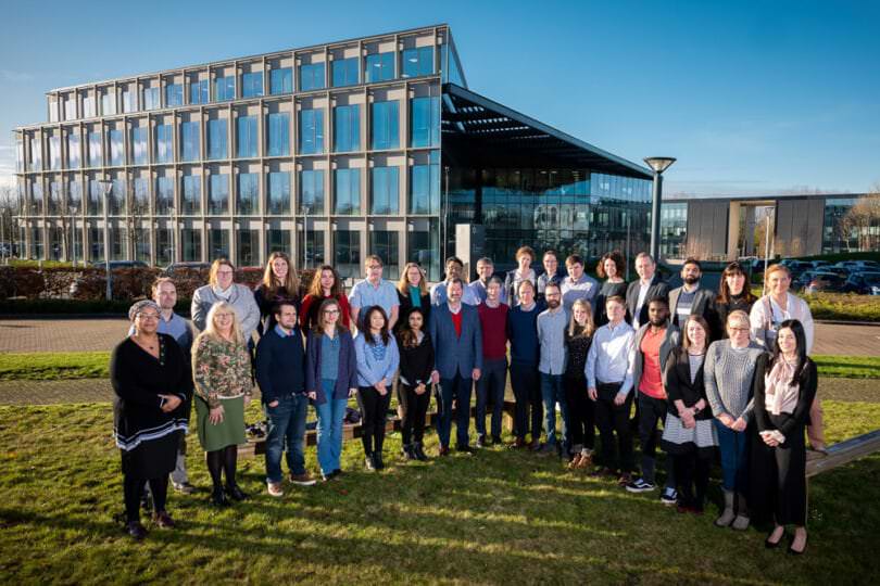 Team photograph at Oxford Science Park of Entire Company in Front of building