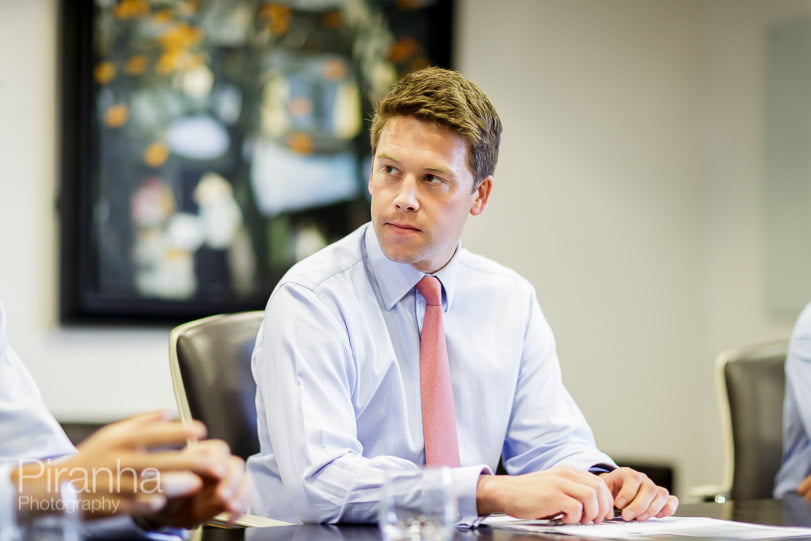 staff of London bank photographed in meeting