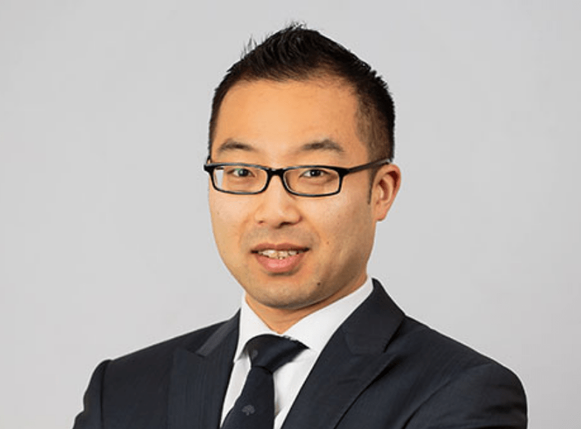 Headshot photograph of employee with white background