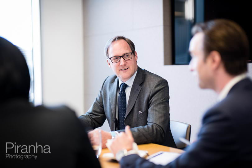 Staff photographed in conversation - business meeting photography