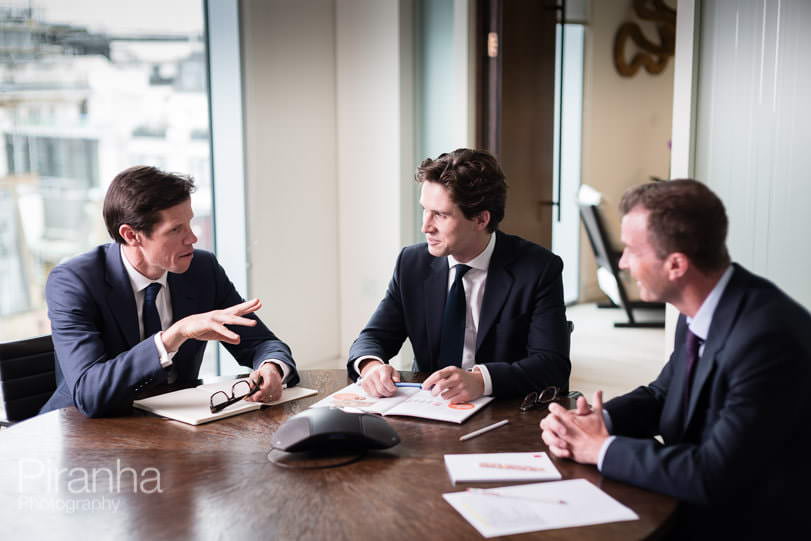 Staff photographed in conversation - business meeting photography