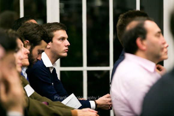 Guests listening at evening event