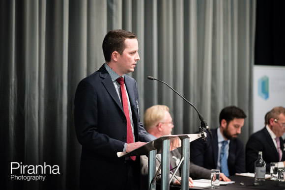 Speaker at podium during London event