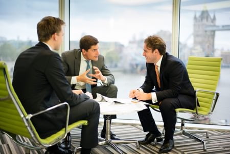 Meeting photograph for company website - conversation with Tower Bridge in background through window