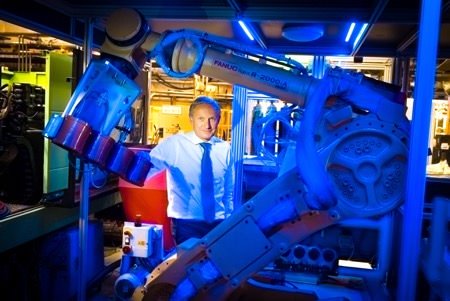 Photograph taken in company factory of director for publications to print