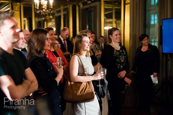 Law Firm Evening Drinks Event with Red Roses England Rugby Team 3 Guests listening to speakers at evening corporate event