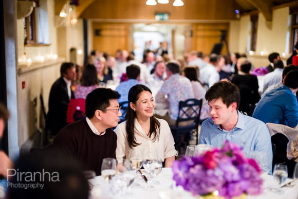 Guests seated at dinner photographed during summer party - event photography of the evening