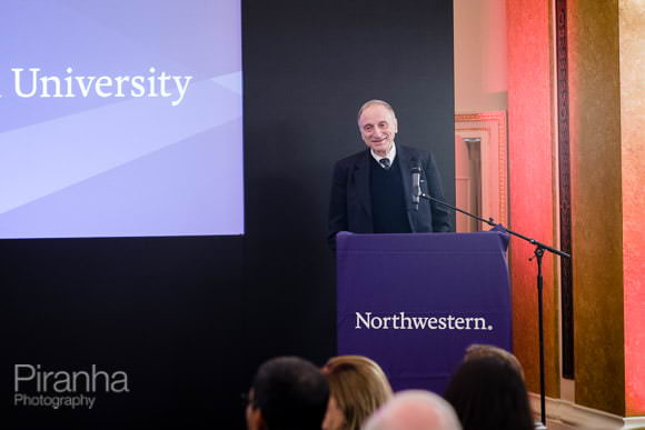 Presenter at alumni event talking to audience