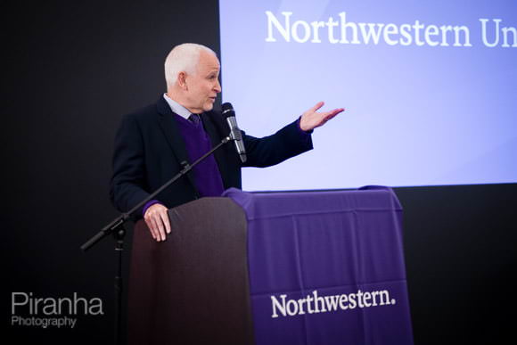 Presenter discussing at alumni event in London