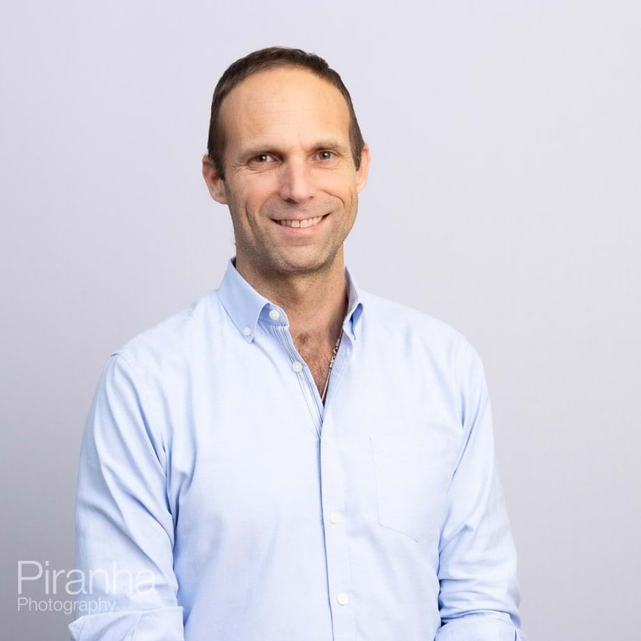 Headshots against white backdrop.