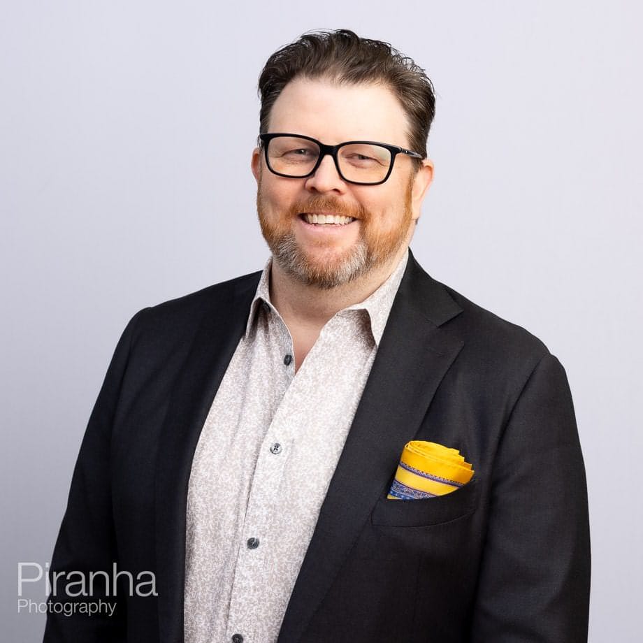 Headshots against white backdrop.