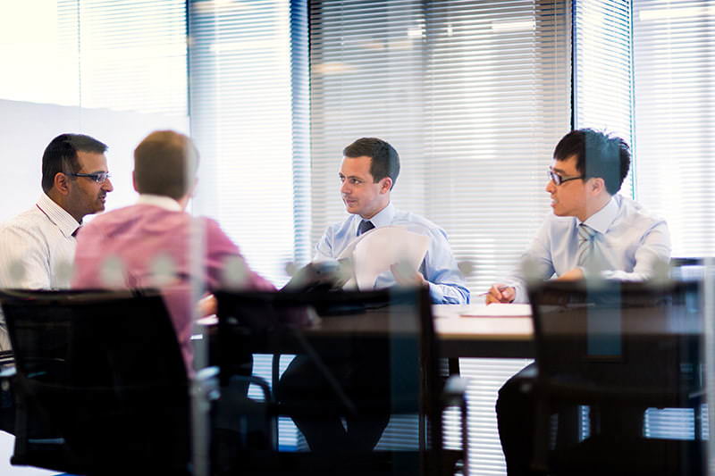Photograph showing group of people in meeing in London offices