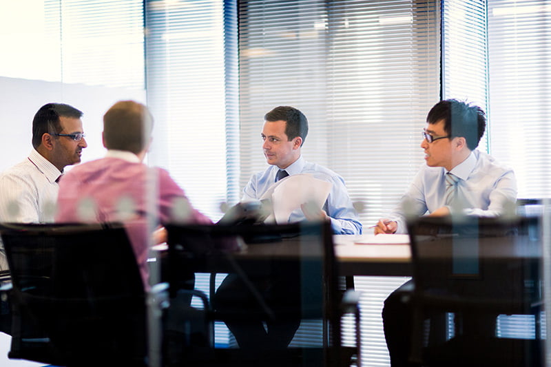 Photograph showing group of people in meeing in London offices