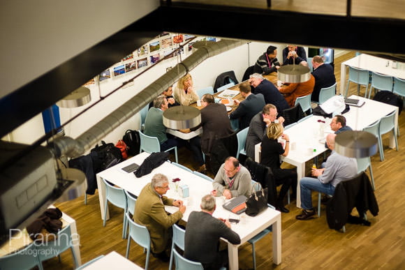 Photograph looking down at employees during conference