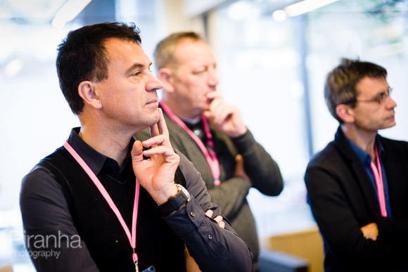 Employees listening to conference speaker presenting 