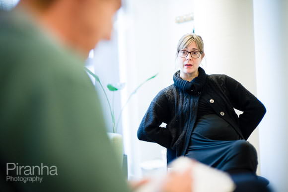 Employees listening to speakers in small groups