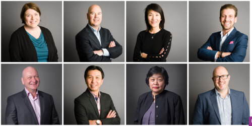 Headshots of employees on grey background