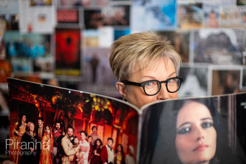 Photograph for publication - woman looking over magazine