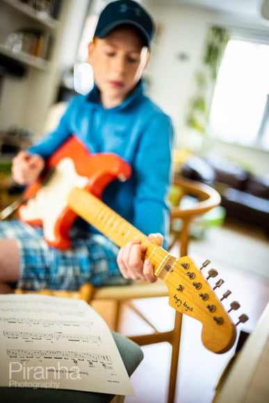 Leica photograph of teenager playing Angry Angus electric guitar