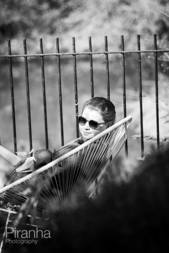 Sitting on the terrace in the sunshine reading a book overlooking the river during lockdown