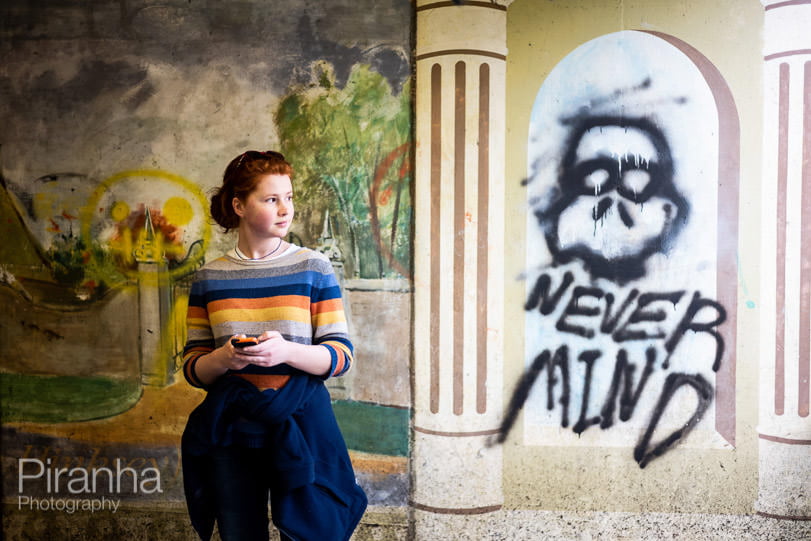 Teenager on lockdown walk in Oxford with graffiti behind her