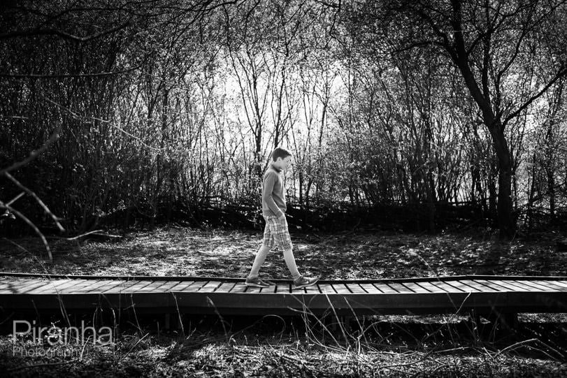 Teenage boy walking through local woodland on lockdown stroll