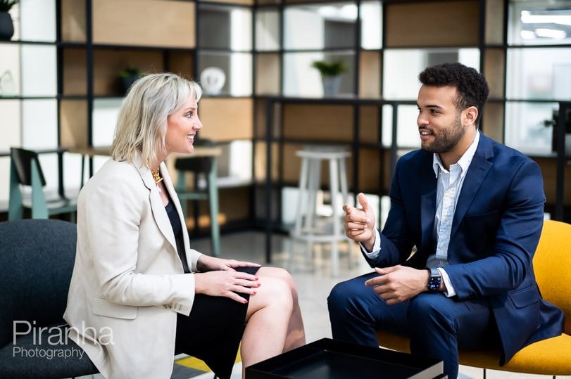 New photographs of two employees in a meeting at their London offices.