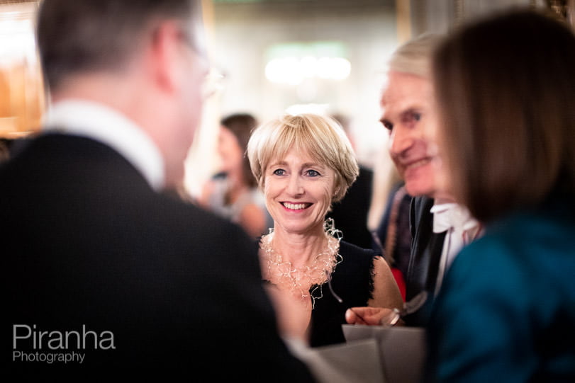 Evening event photography at Fishmongers' Hall in London - guest chatting with friends