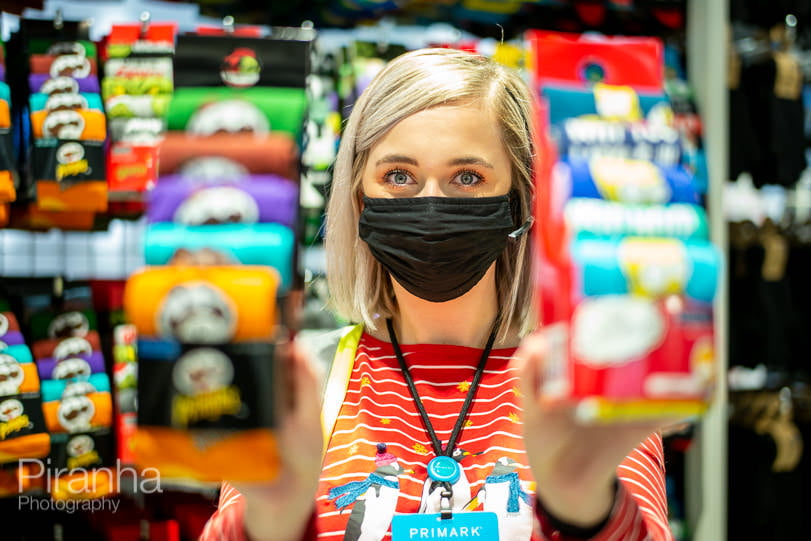 assistant in store wearing a mask once lockdown lifted