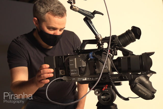 Corporate videographer at work with camera in London during filming