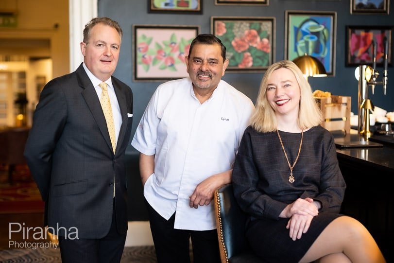 Management team photographed together in bar or venue.