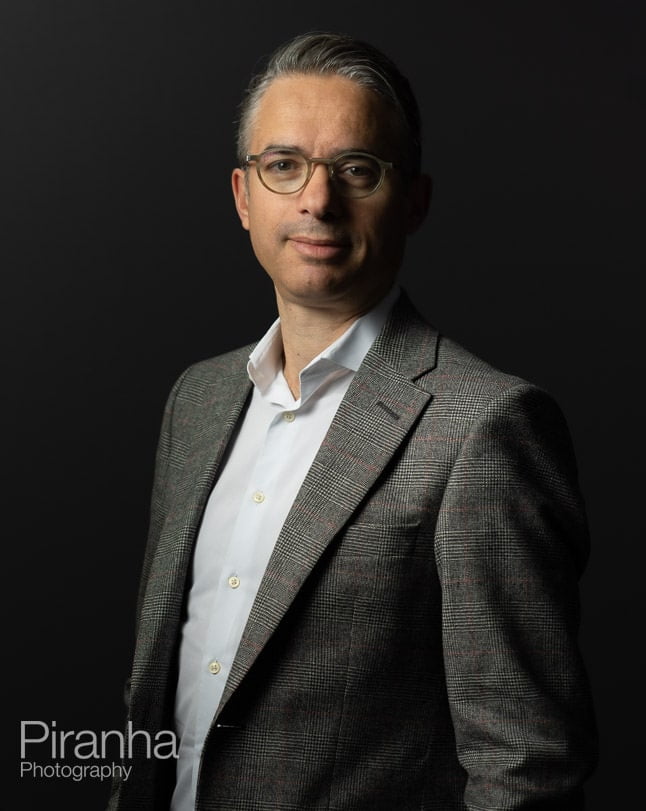 Headshot photography against grey backdrop.