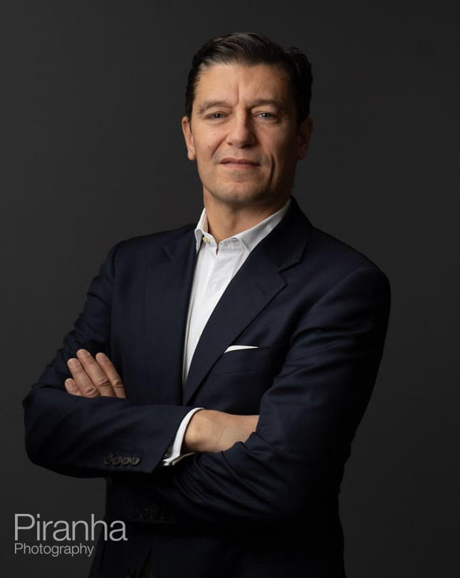 Headshot photography against grey backdrop.