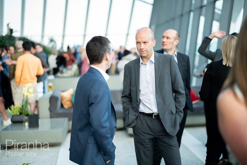 Photography of guests in conversation at company anniversary party in Walkie Talkie Building - Sky Garden