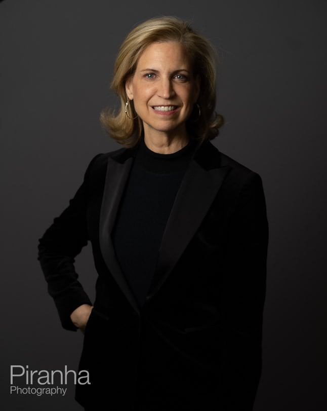 Headshot photography against grey backdrop.