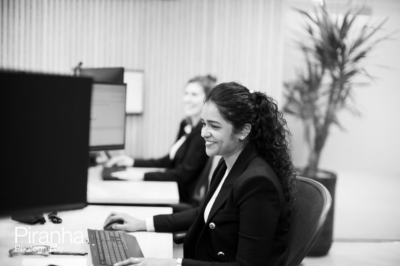 Black and white office photography showing staff at work.