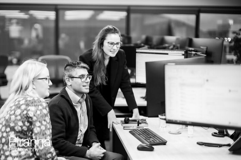 Black and white office photography showing staff at work.