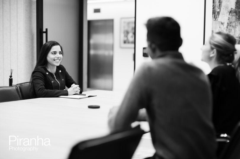 Black and white office photography showing staff at work.