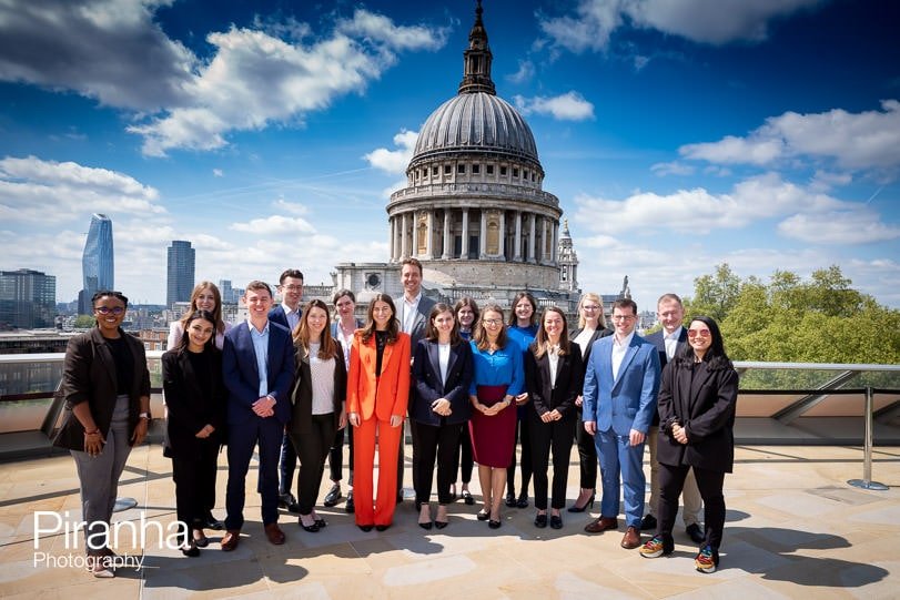 Company's group photograph taken outside with St Paul's Cathedral behind