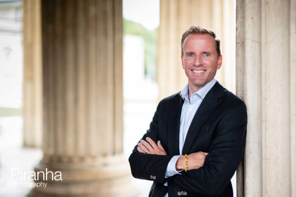 Headshot photograph taken of private equity company Director by Piranha Photography on location in Europe - not AI generated.