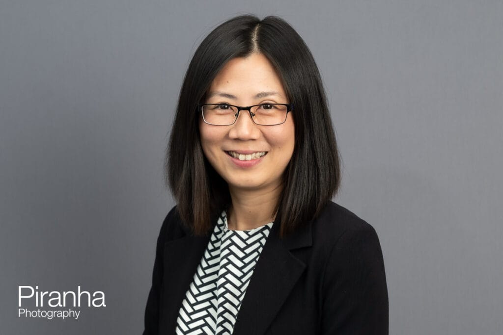 Could AI Generated Images Replace Corporate Headshot Photography? 2 Headshot photograph taken against grey backdrop by Piranha Photography - not AI generated.