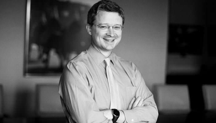 Portrait photograph of Mark McComiskey, Chairman of Torus in black and white
